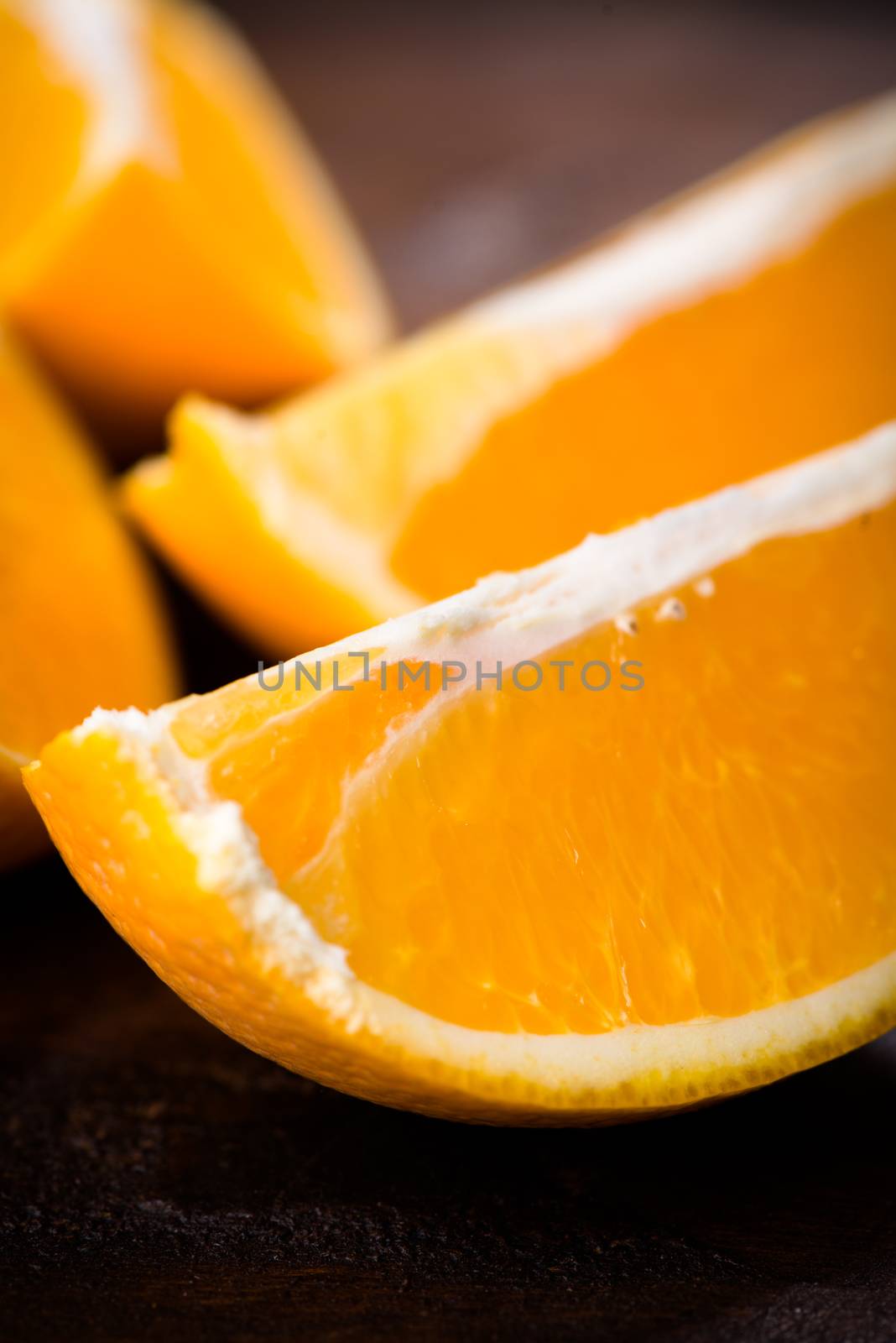 Sliced close up citrus on dark background by Nanisimova