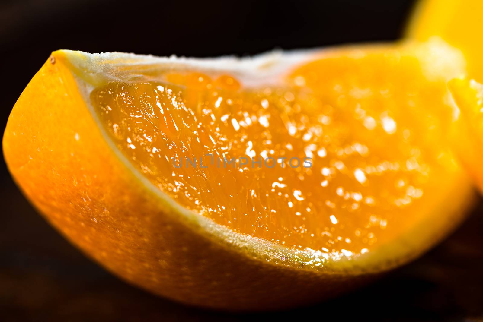 Sliced close up oranges on dark background with selective focus