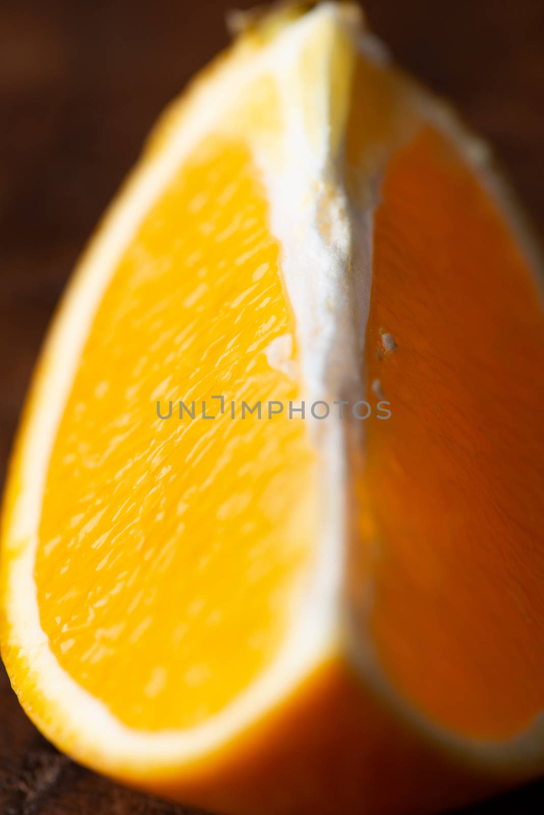 Sliced close up oranges on dark background with selective focus