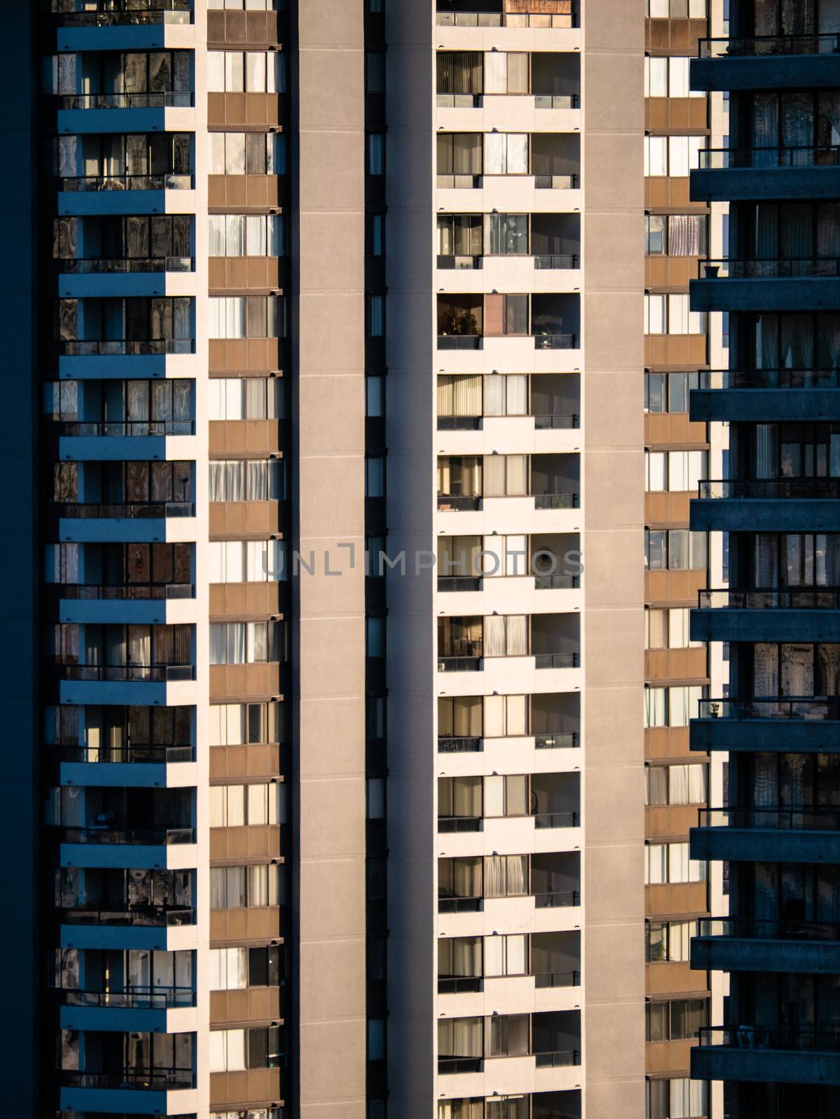Facade of residential high-rise towers on bright sunny day by Imagenet