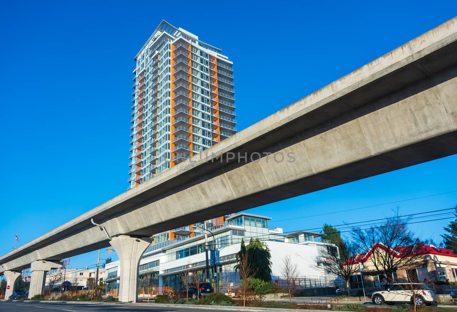 Skytrain rail lane in front of residential tower building