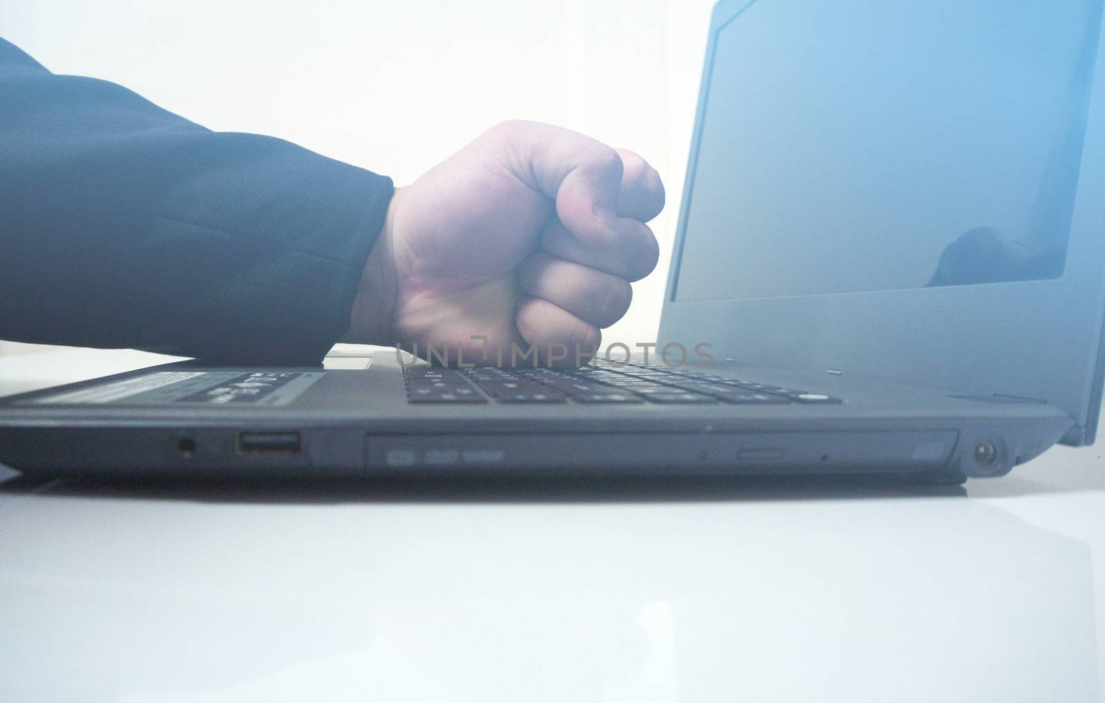 Problems of laptops at work. Office upset from work. Fists smashing computers