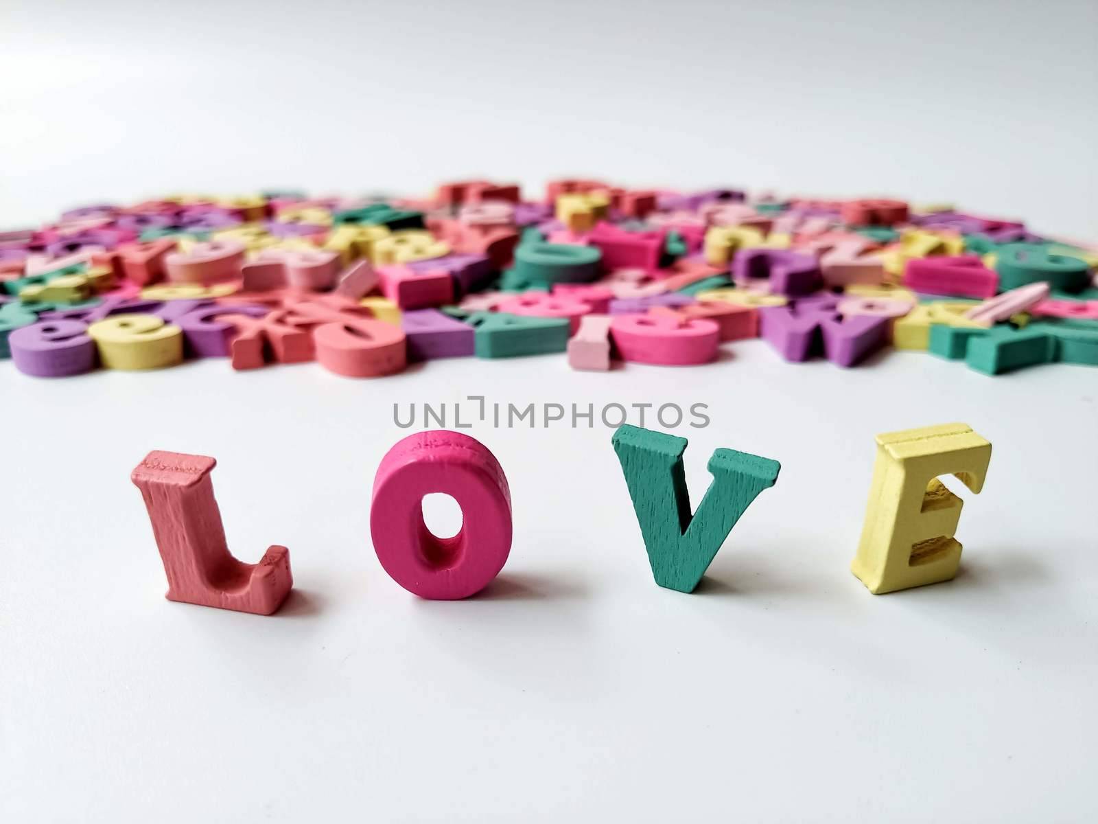 Children's colored letters placed on a white background.