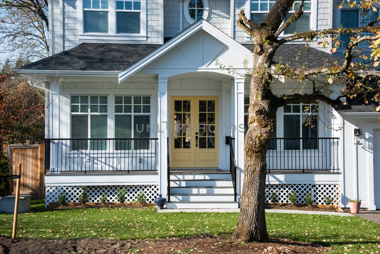 Entrance doors of residential house under the porch. Entrance of detached residential house on bright sunny day