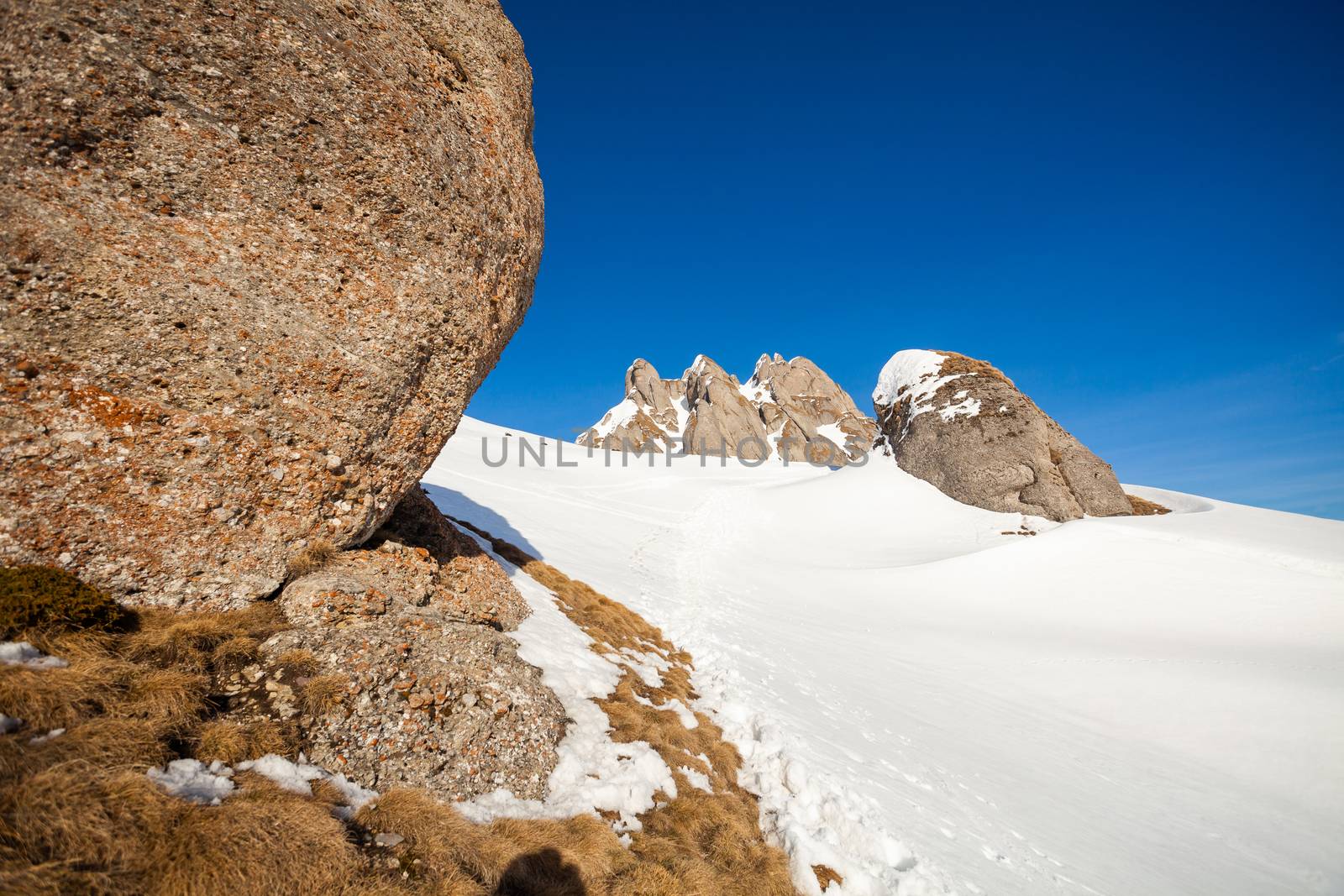 View of Mount Ciucas peak on a sunny winter day with beautiful rock formations, part of Romanian Carpathian Range