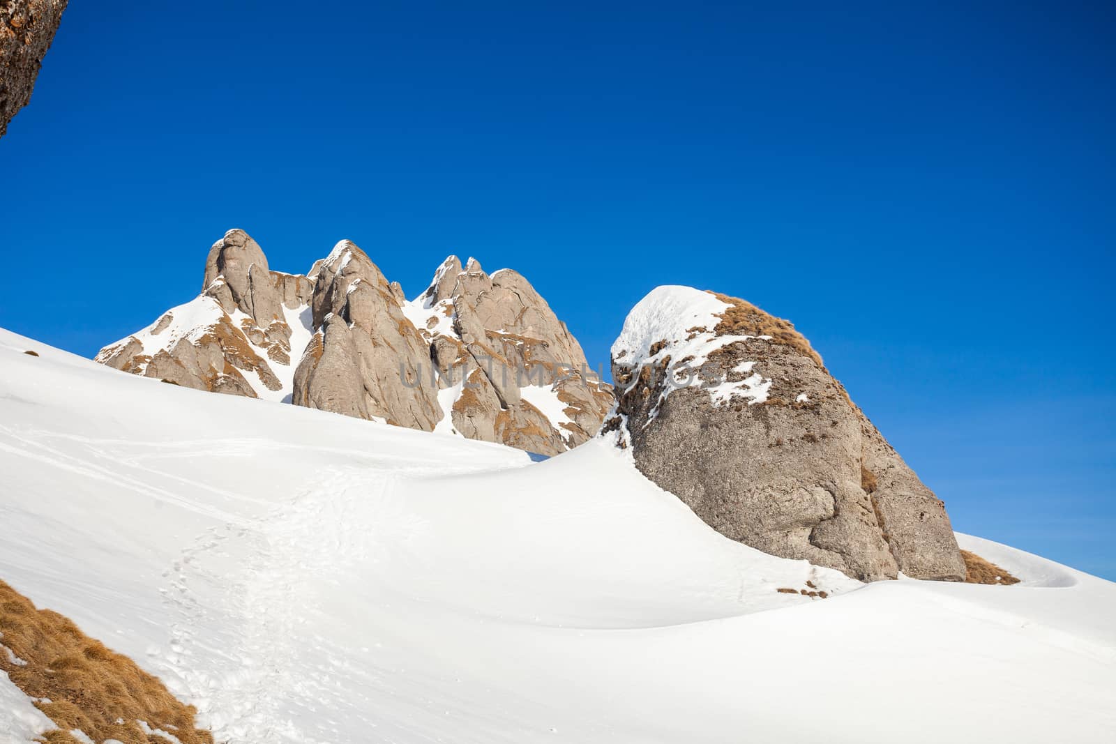 View of Mount Ciucas peak on a sunny winter day with beautiful rock formations, part of Romanian Carpathian Range