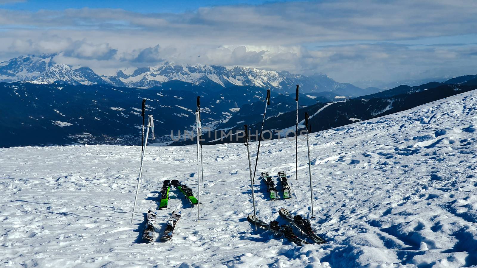 Skis In The Snow on Ski Piste With Against snowy Mountains
