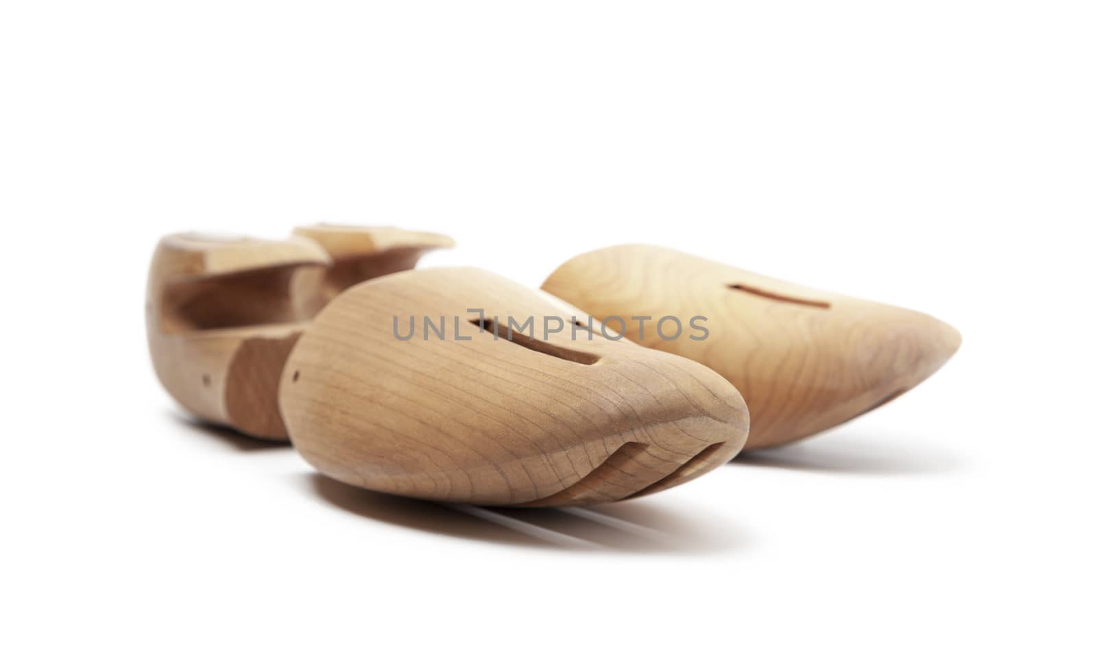 Selective focus of men's wooden shoe stretcher isolated on a whi by SlayCer