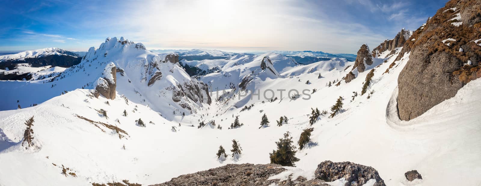 Panoramic view of Mount Ciucas peak at a sunset on winter, part of Romanian Carpathian Range