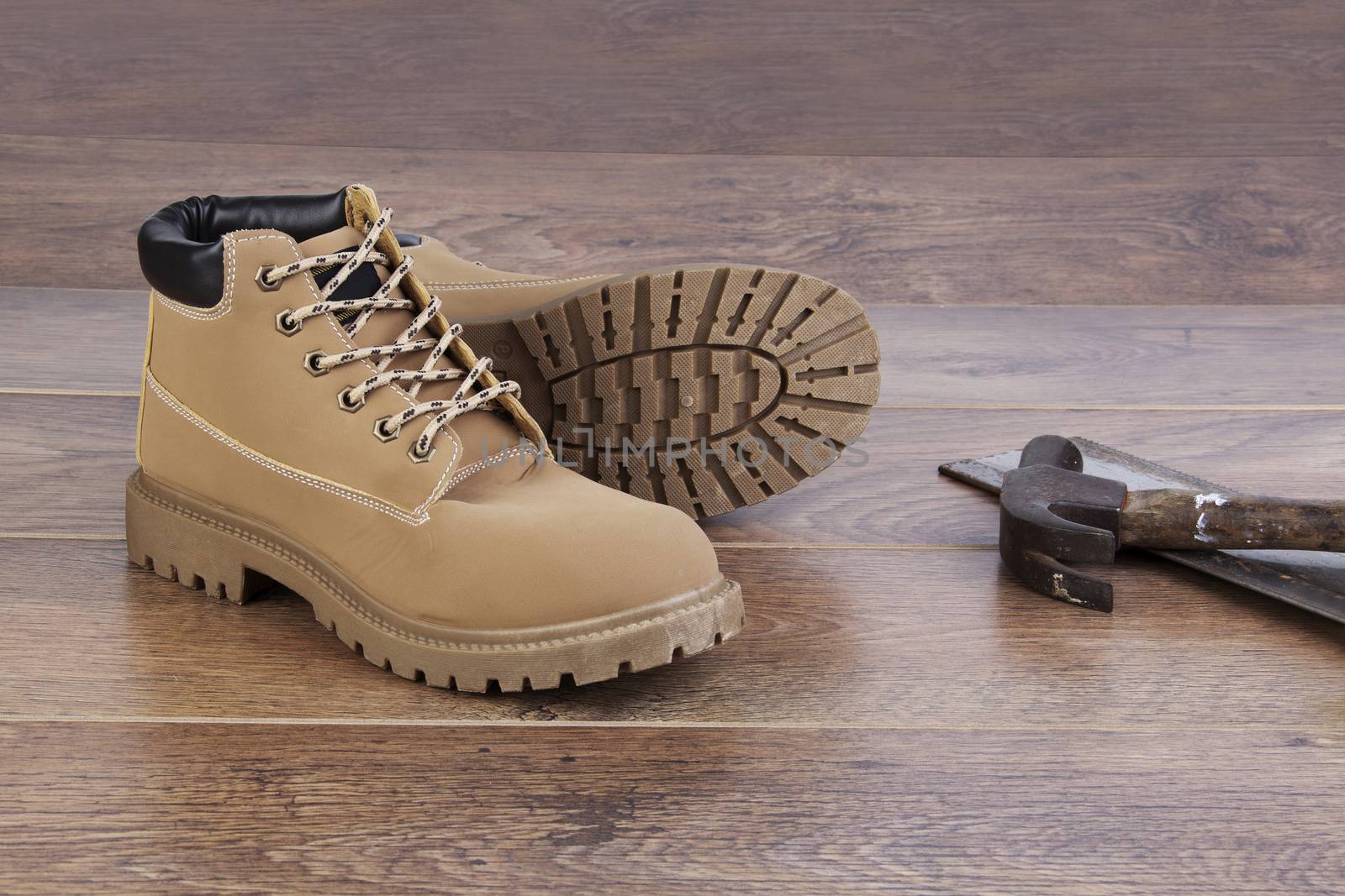 Work boots on wooden floor with tools