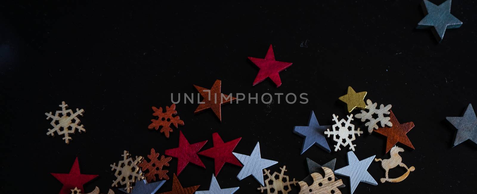 Christmas wooden holiday decor on black background with copy space