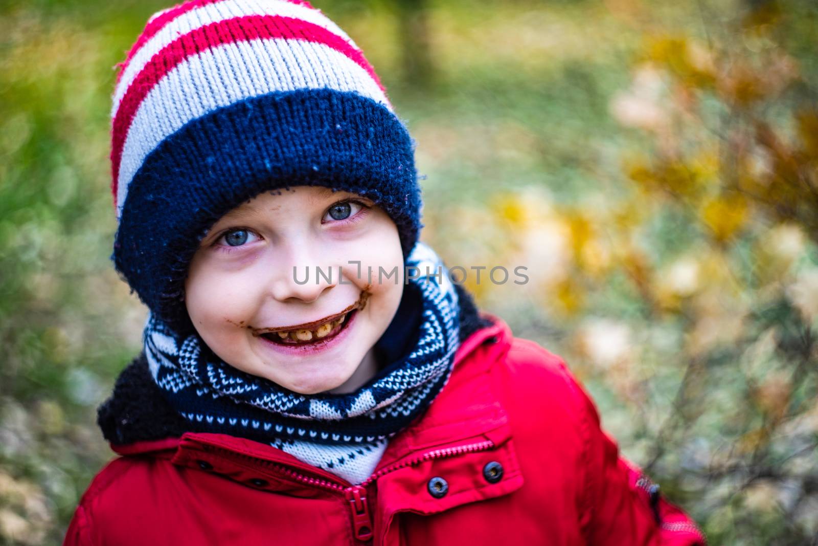 Nice boy drinking hot chocolate outdoor and have fun