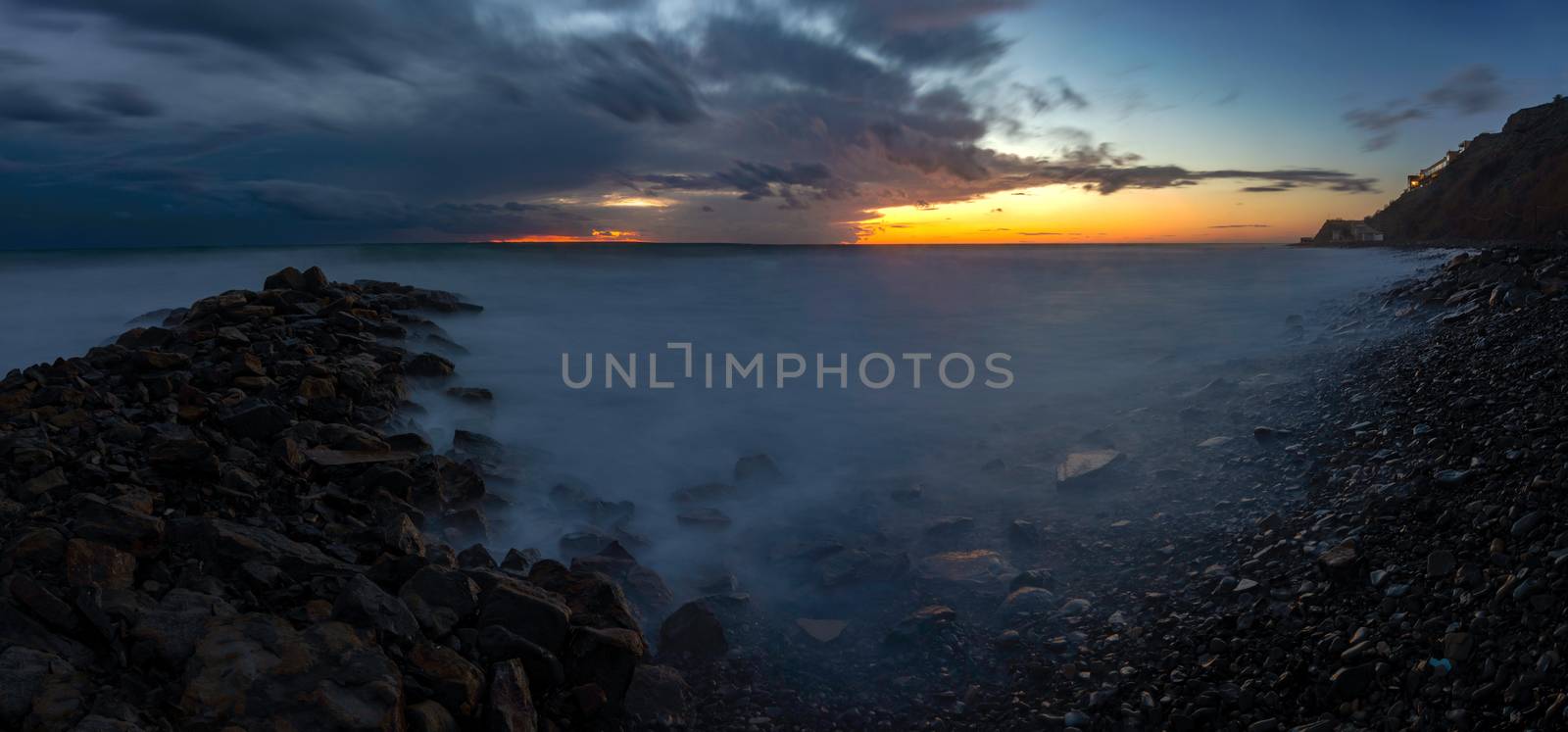 Panorama of three frames a general view of the rocky shore of the Black Sea coast after sunset, Anapa, Russia by Madhourse