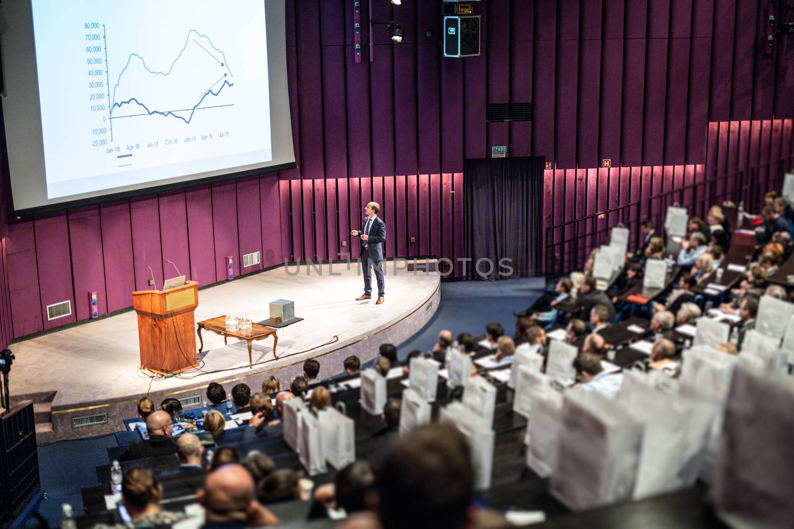 Speaker Giving a Talk at Business Meeting. Audience in the conference hall. Business and Entrepreneurship concept.