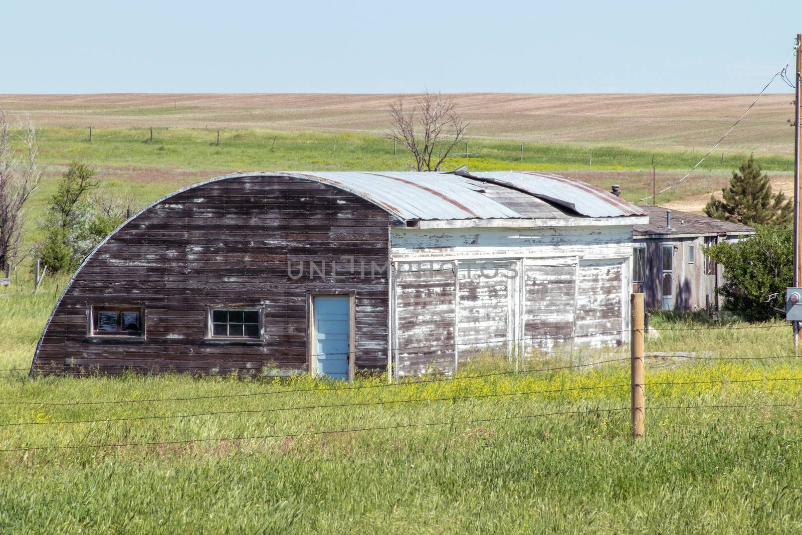An old barn in a grassy field. High quality photo