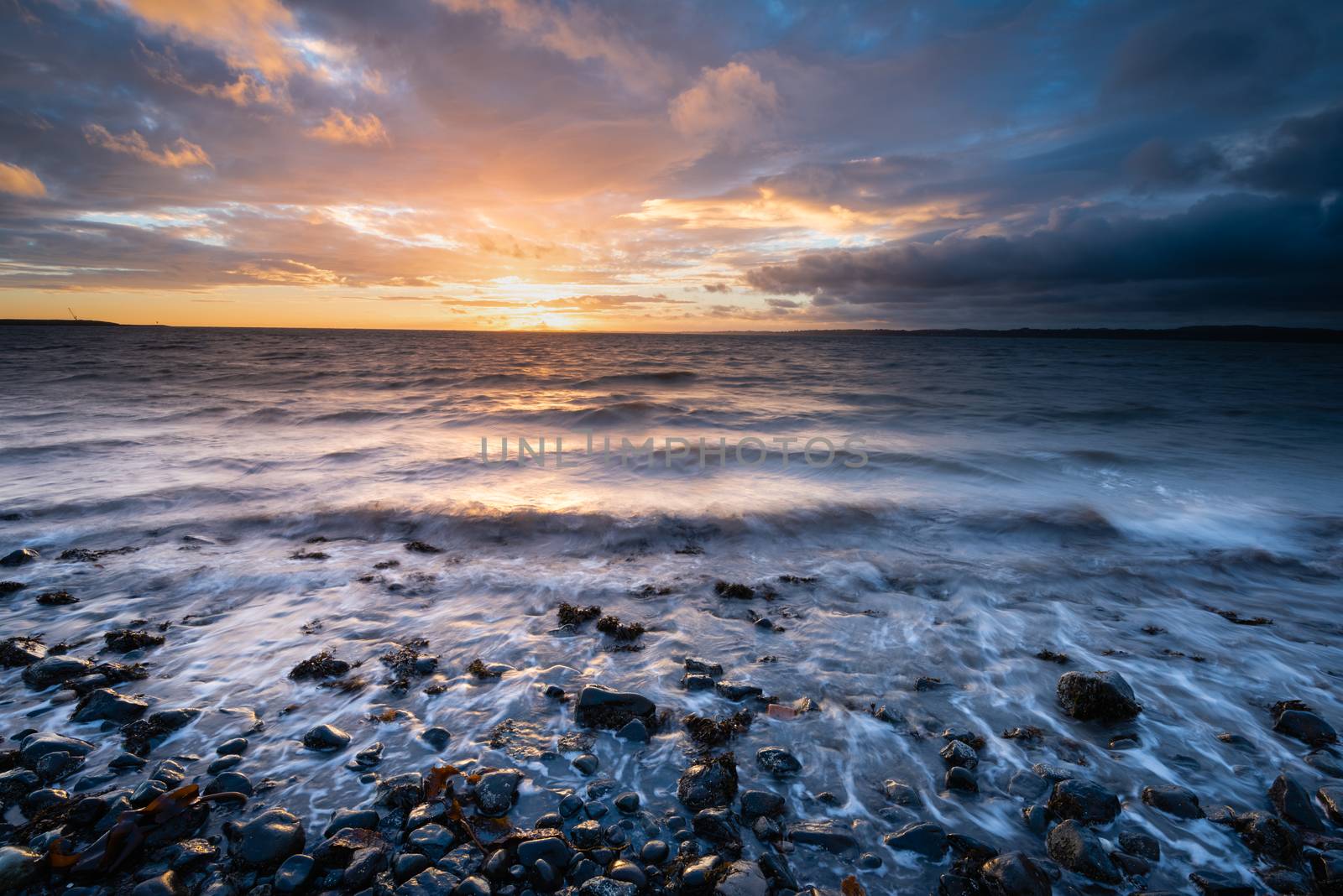 Dawn on Belfast Lough, viewed from Downshire beach, Carrickfergus, County Antrim, Northern Ireland.