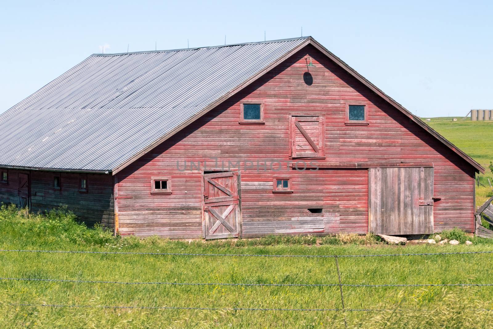 An old barn in a grassy field. High quality photo