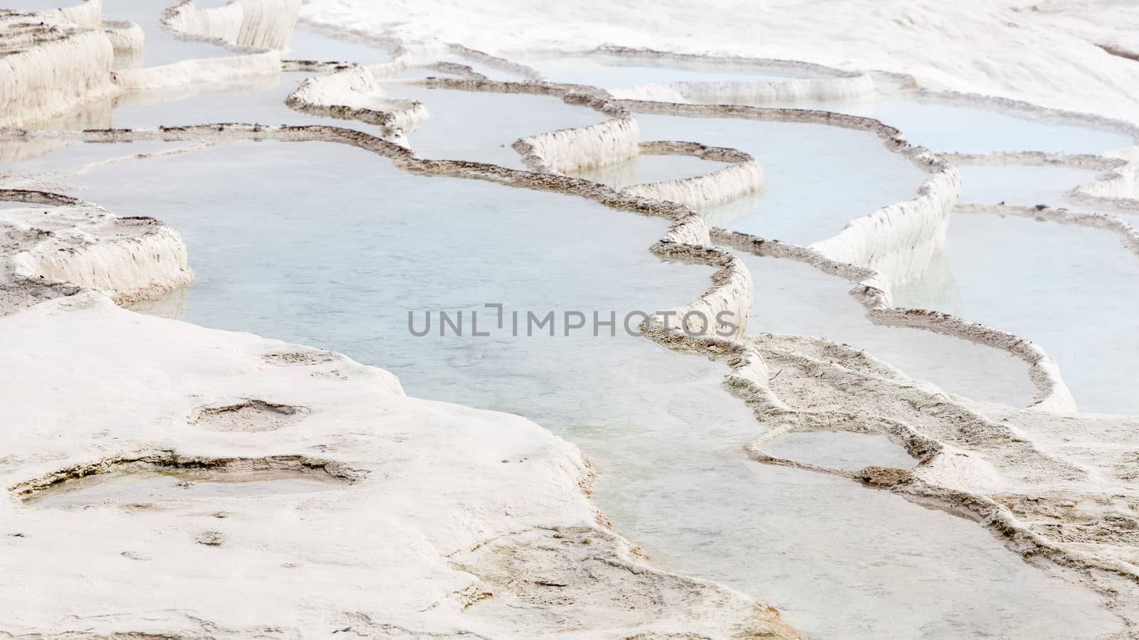 The view across a white travertine hot spring in Pamukkale, southwestern Turkey.  The site is a UNESCO World Heritage Site.