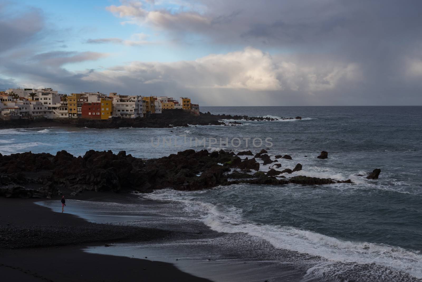 Puerto de la Cruz, Tenerife, Spain -Jaunary 9, 2020:  Sunset view to cape Punta Brava from Famous beach Playa Jardin with black sand in Puerto de la Cruz, Tenerife, Spain