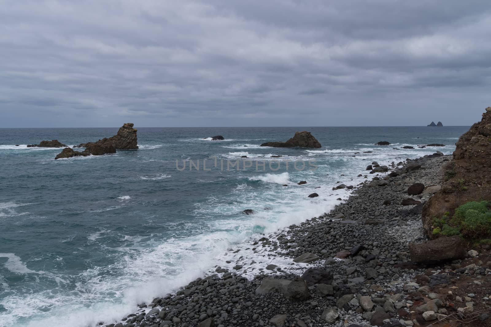 View to waves and Los Galiones cliff near Roque de Las Bodegas beach in the area of Taganana, Tenerife Island,  Spain