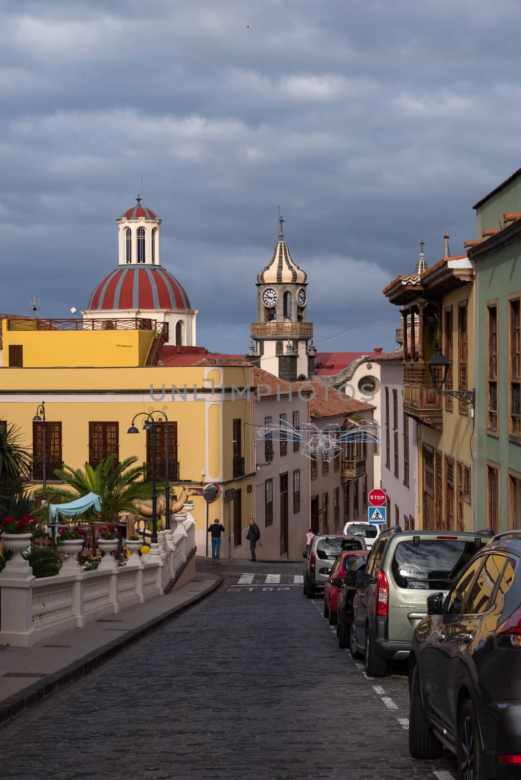 La Orotava, Spain -January 12, 2020: Street with typical colonial style houses on medieval street of old town la Orotava with Church of Nuestra Senora de la Concepcion (Church of Our Lady of Conception)