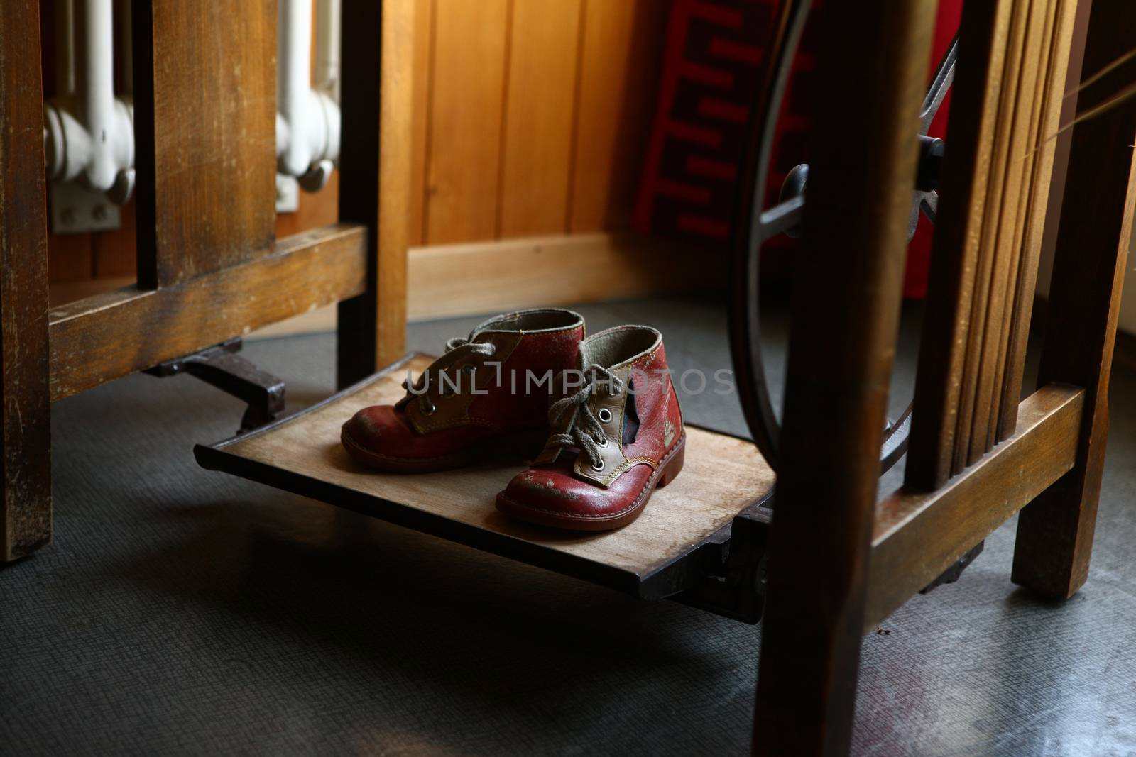 Old red shoes on display in old home with dramatic lighting