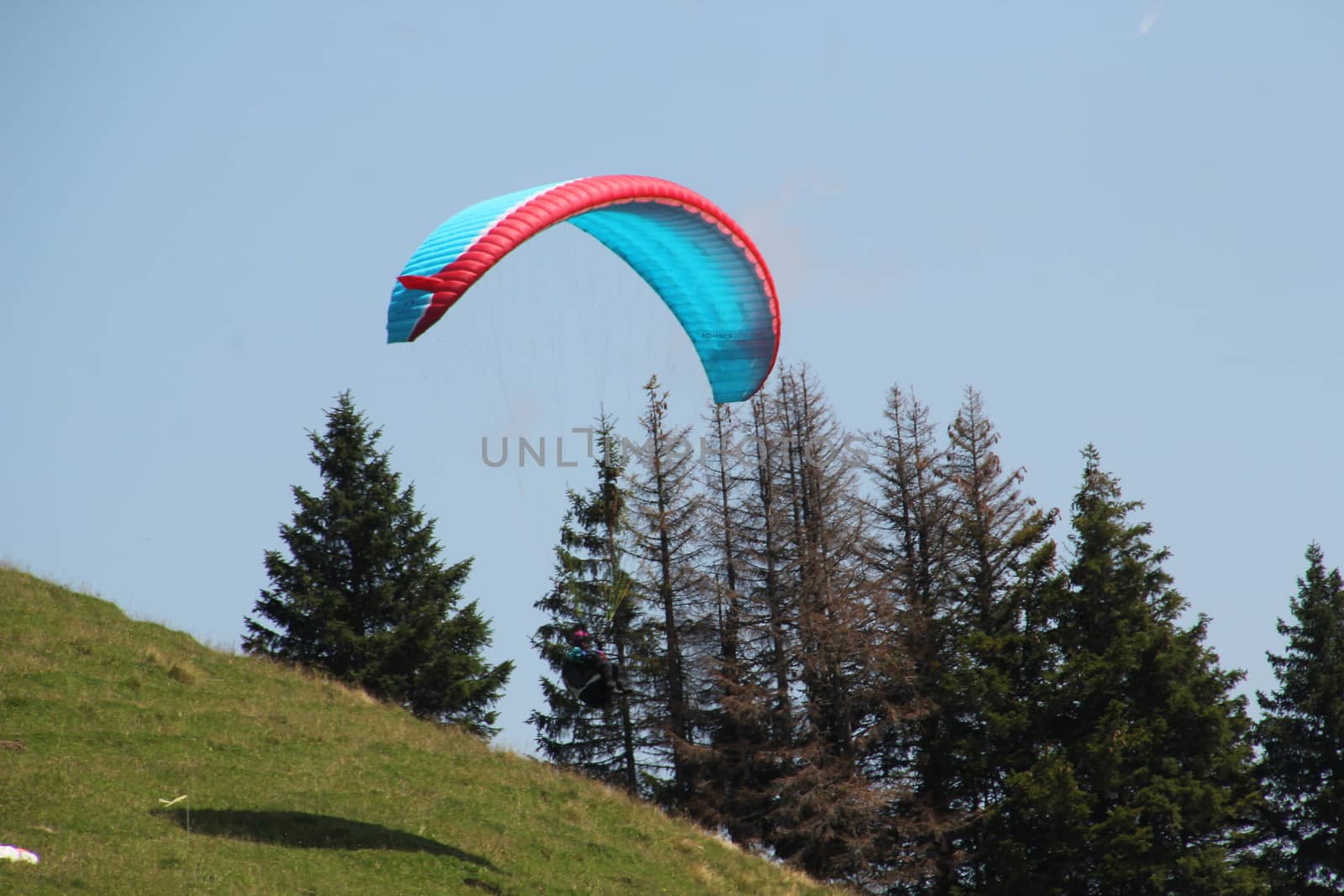 para gliding somewhere in the alps with blue sky