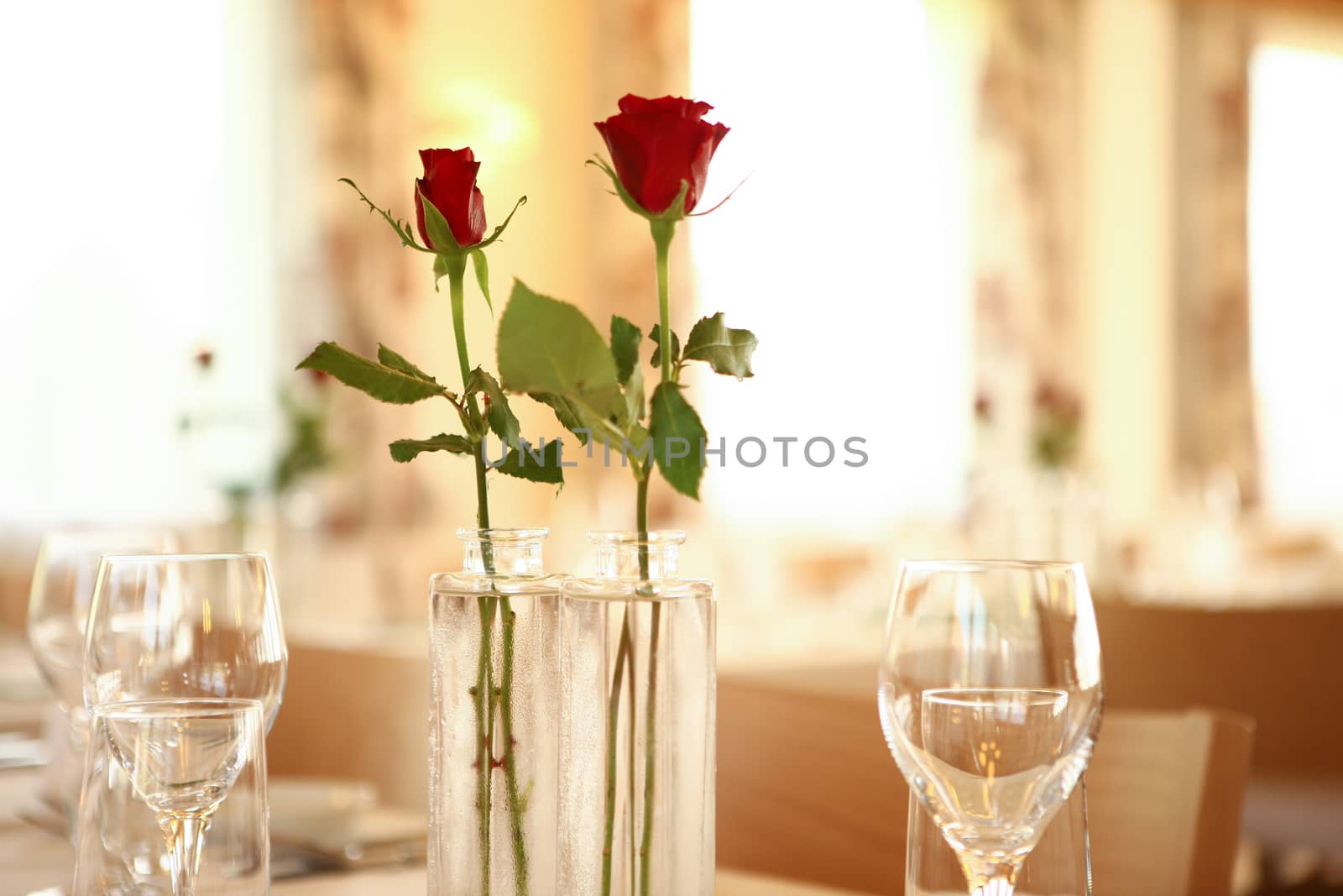 red roses on table set for guest to arrive in a restaurant