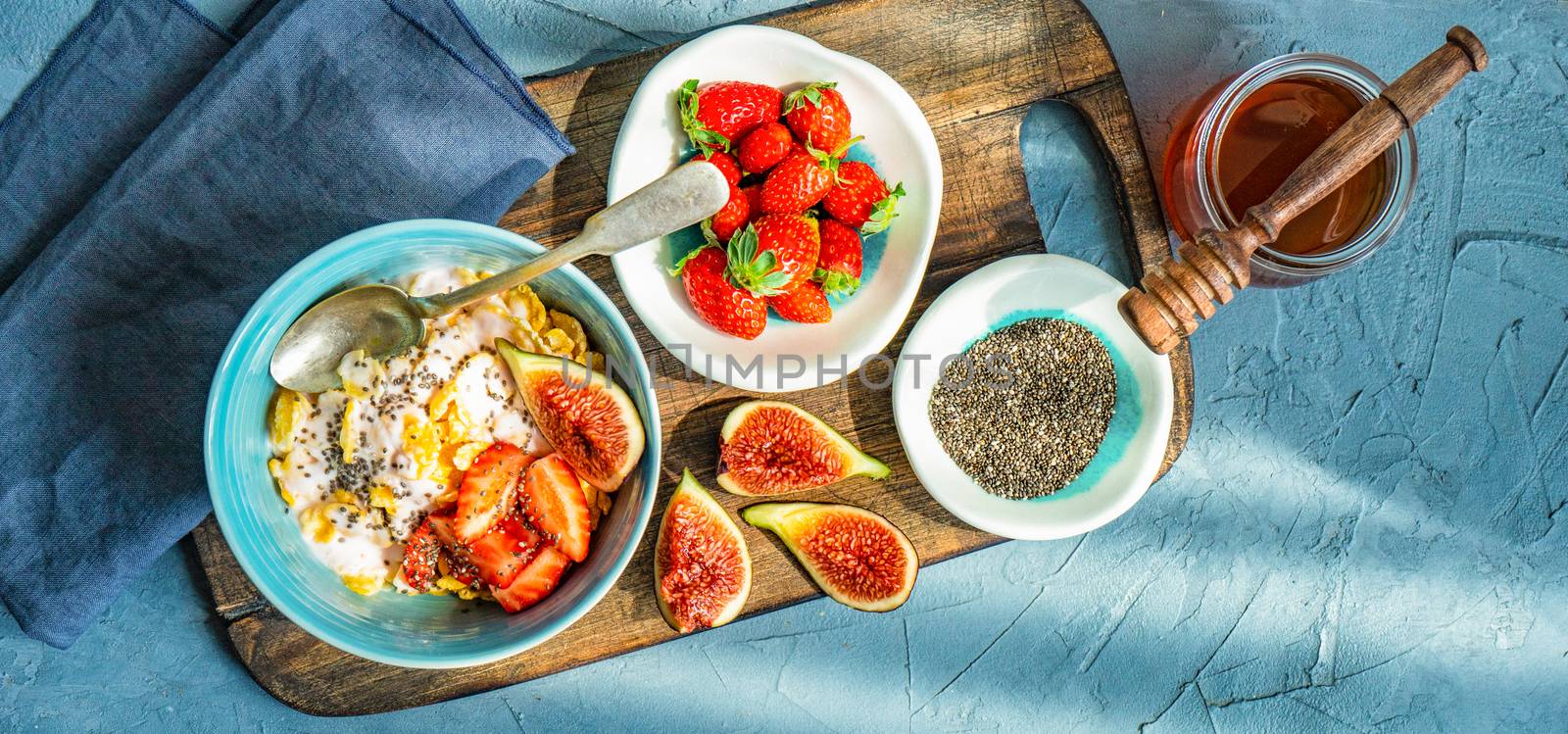 Traditional healthy breakfast with fresh organic strawberry and figs, chia seeds, yogurt and honey