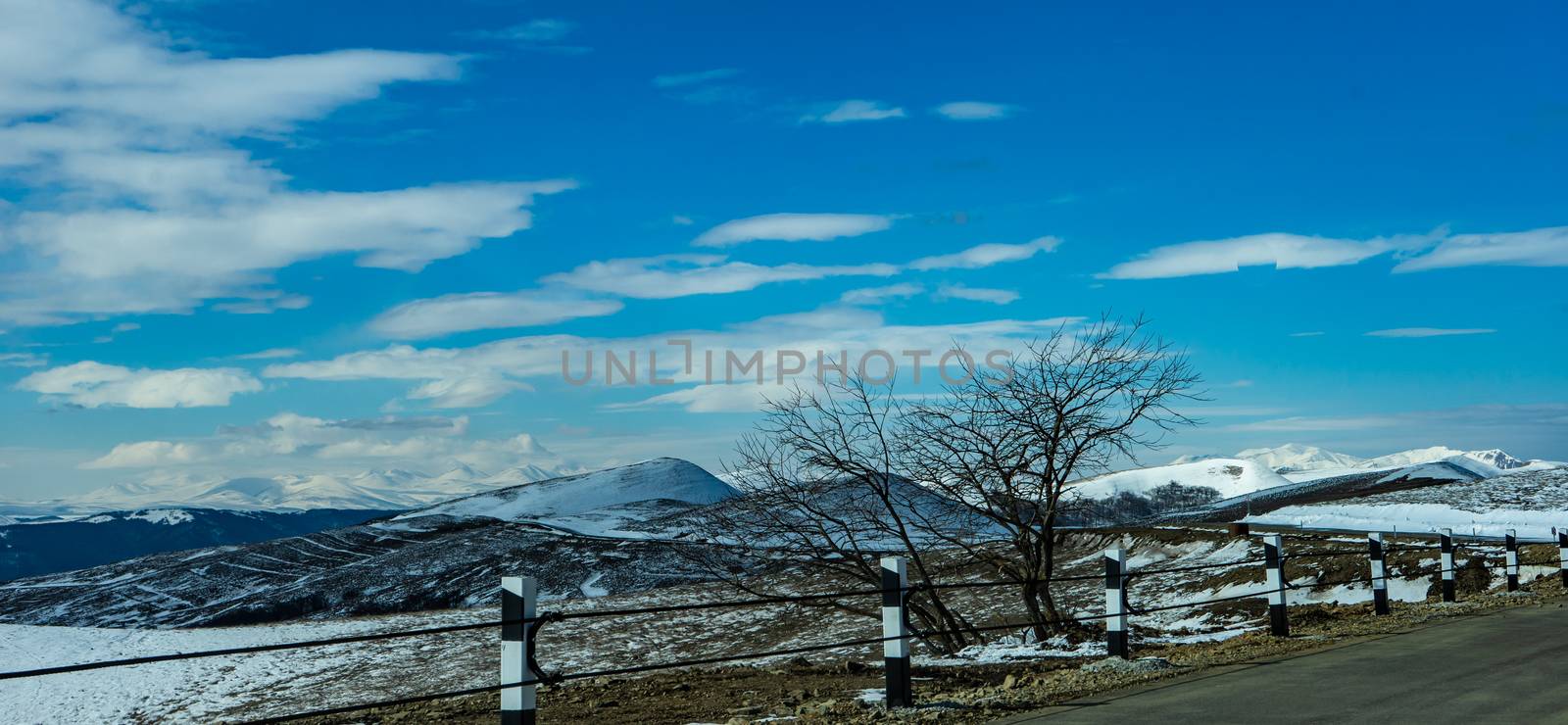 Blue winter sky and road in mountain, winter time in Caucasus mountain range close to Tbilisi, Georgia