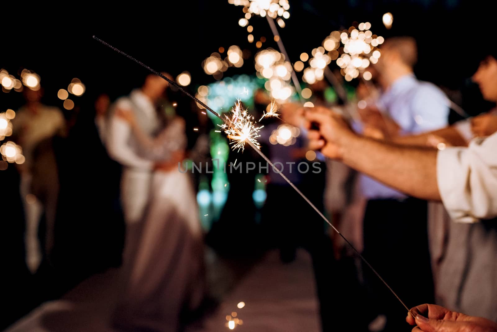 sparklers at the wedding,  on the background by Andreua