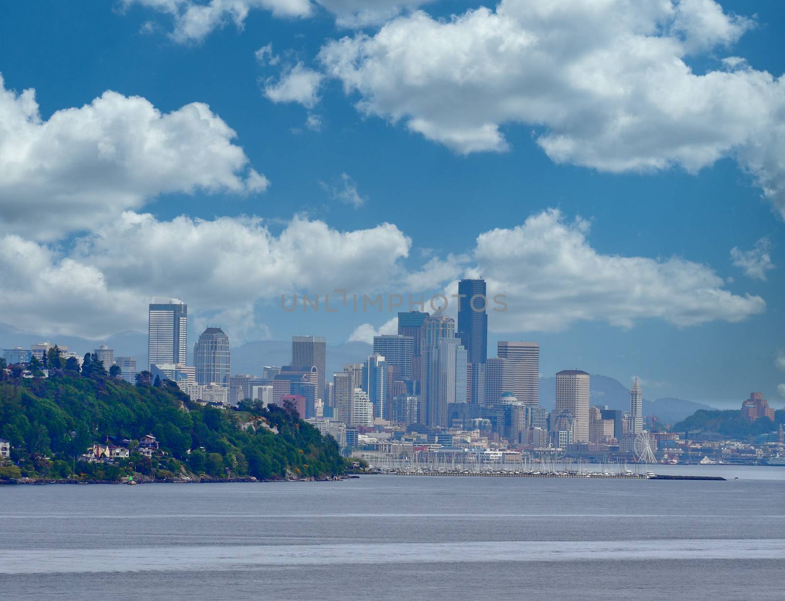 A view of Seattle from beyond a point of land with Space Needle in distance