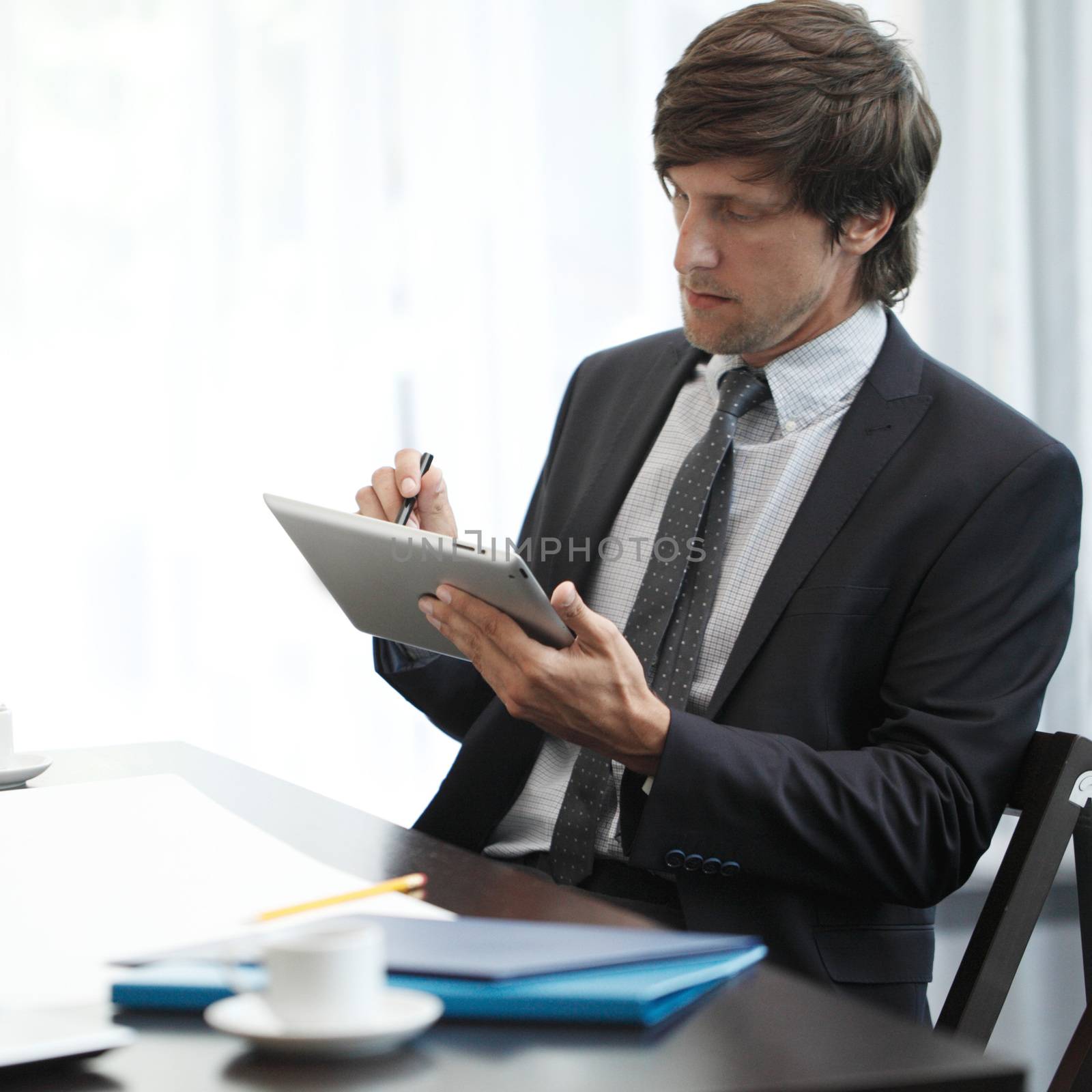 Business man with tablet pc by ALotOfPeople