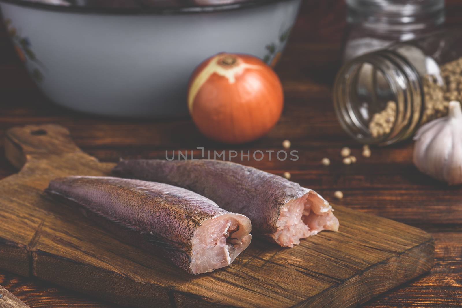 Hake carcasses on cutting board by Seva_blsv