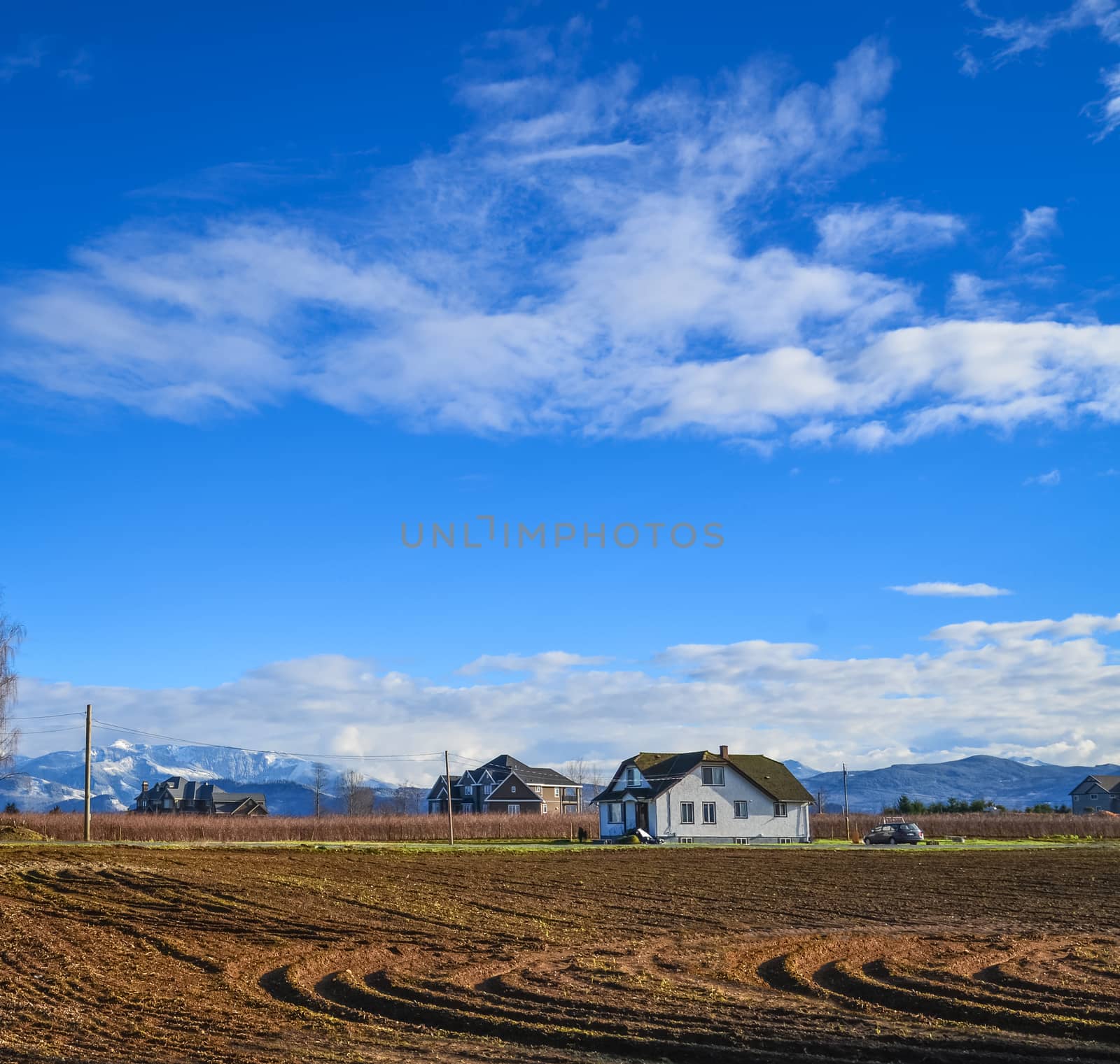 Farmers' houses on the field on winter season in British Columbia by Imagenet