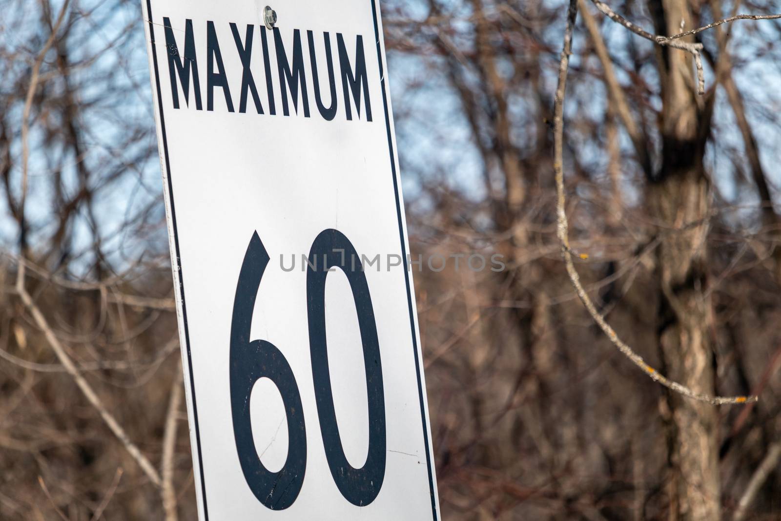 A speed limit sign is positioned in a frame to show the word 'Maximum' and the number sixty (60), but no unit of measurement is shown.