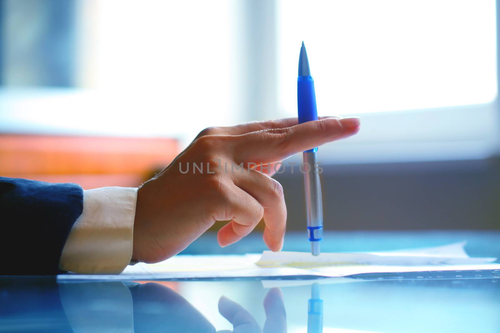 Image of human hand with pen during seminar or conference business office work concept background