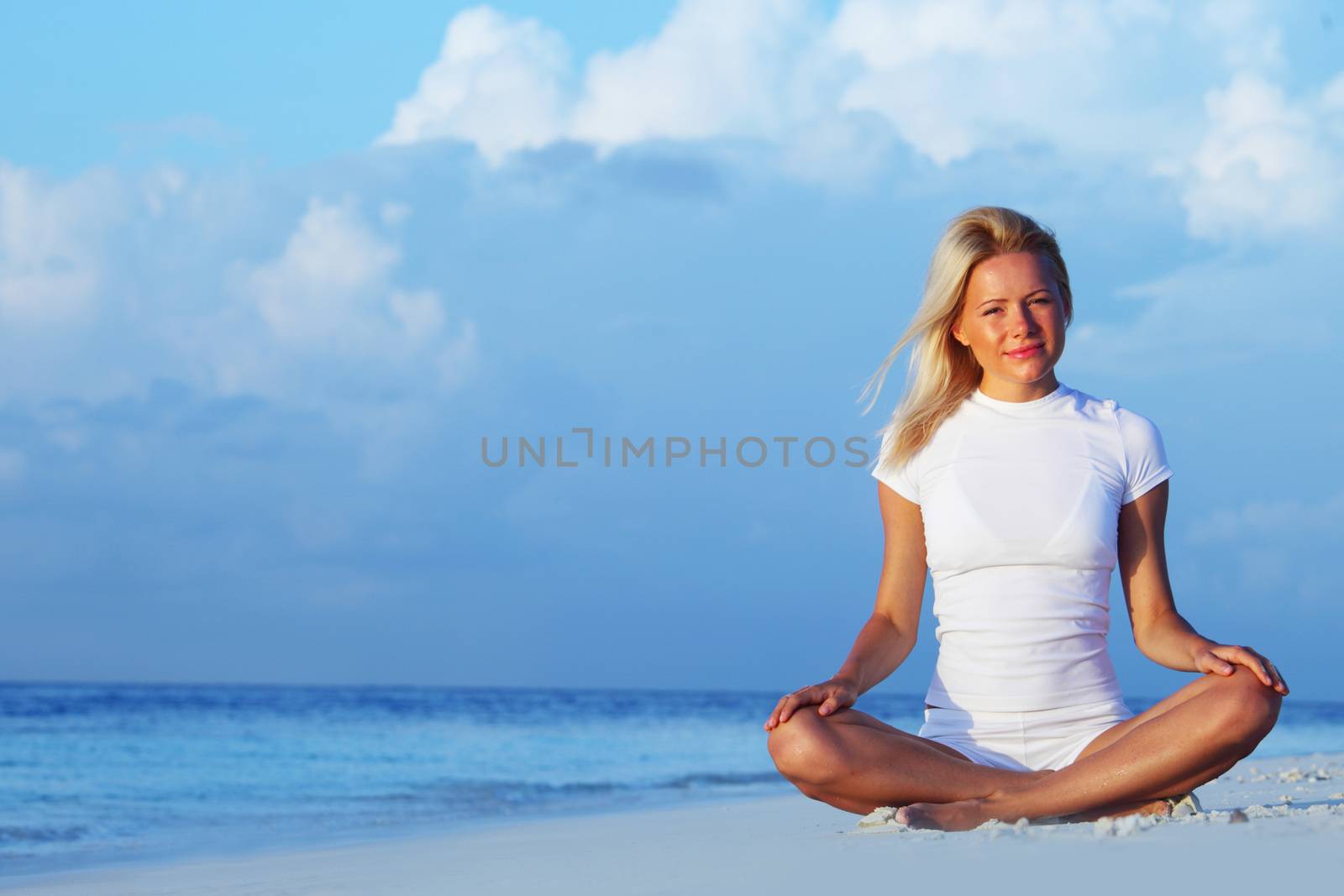 Yoga woman on sea coast by Yellowj