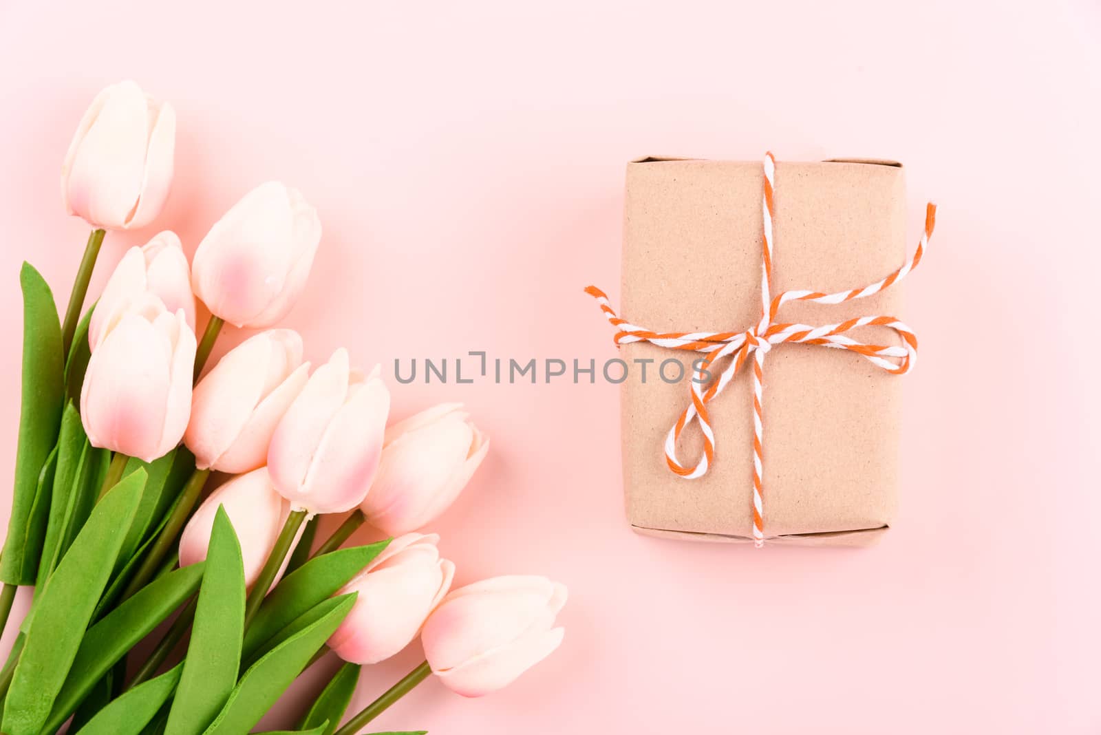 Happy Women's Day, Mother's Day concept. top view flat lay gift box and Tulip flower on pink background, copy space for your text