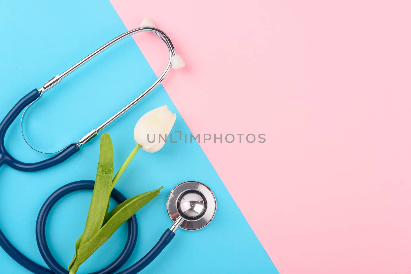 Doctor's Day concept, flat lay top view, stethoscope with red heart on pink blue background, diagnosis of heart disease with copy space for text