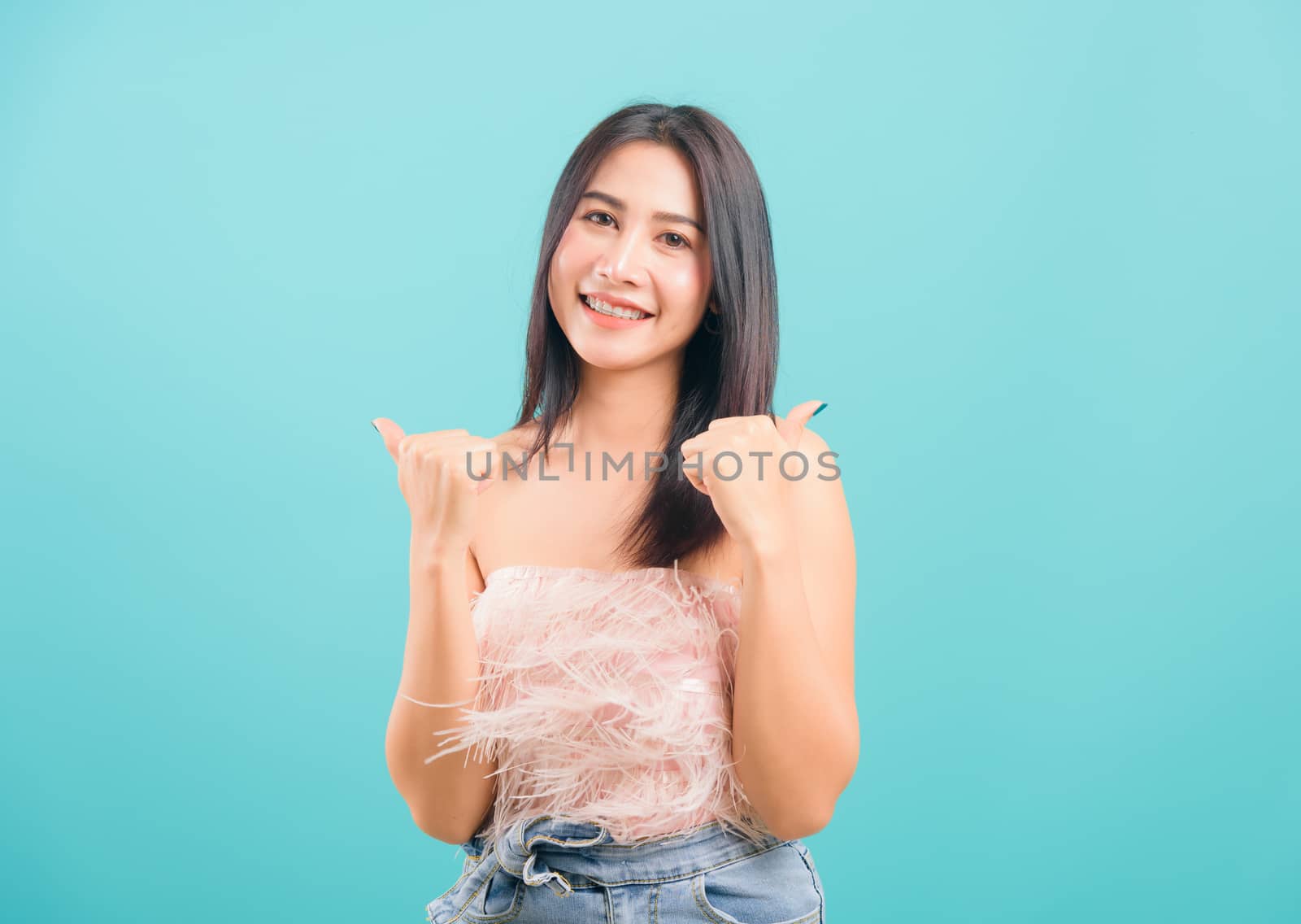 Portrait asian beautiful woman smiling showing hand showing thum by Sorapop