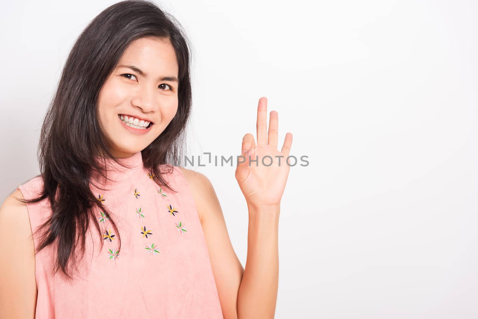 Portrait Asian beautiful young woman made finger OK symbol sign  by Sorapop