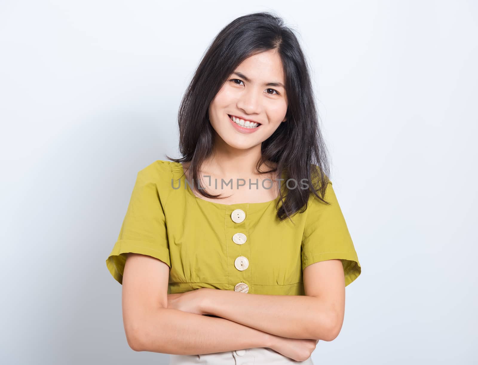 Portrait Asian beautiful young woman standing smile seeing white teeth, She crossed her arms and looking at camera, shoot photo in studio on white background