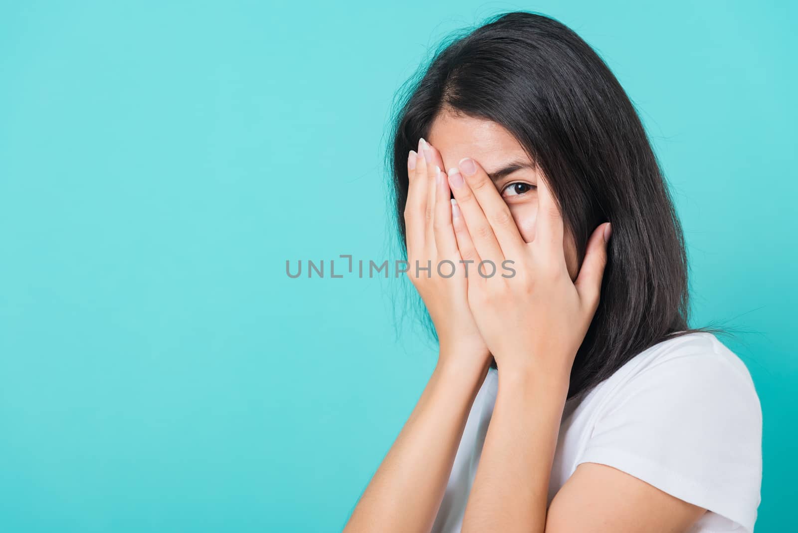 woman smile white teeth wear white t-shirt standing peeking thro by Sorapop