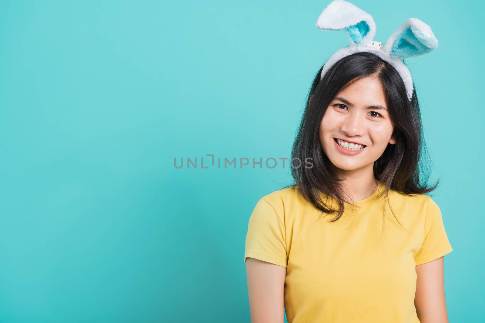 woman smile white teeth wear yellow t-shirt standing with bunny  by Sorapop