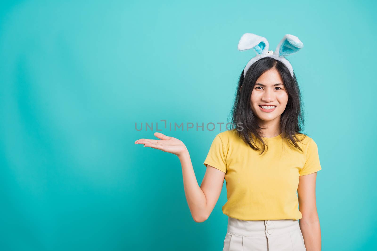 woman smile white teeth wear yellow t-shirt standing with bunny  by Sorapop