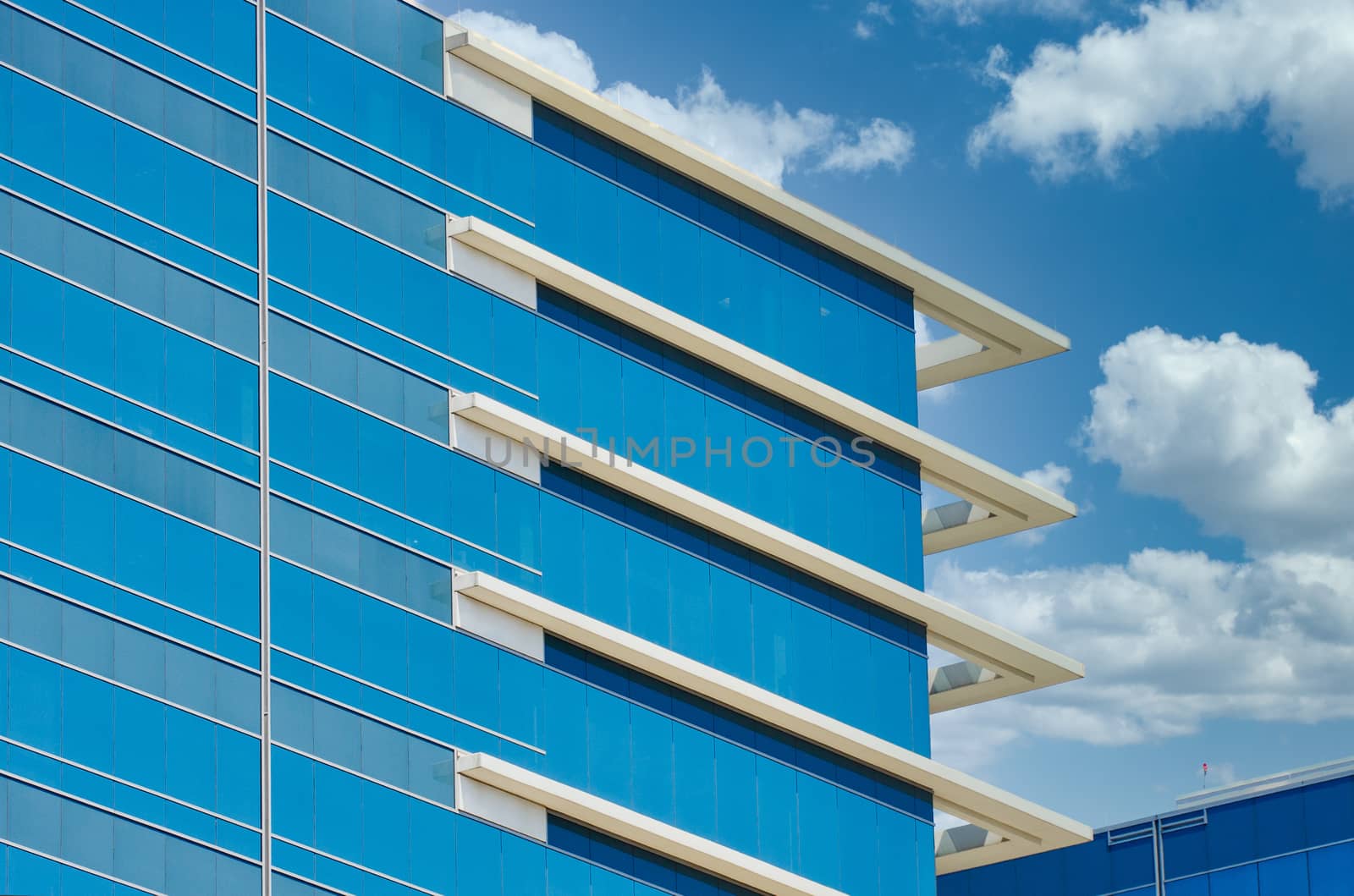 Blue Glass Office Building with White Corner Trim by dbvirago