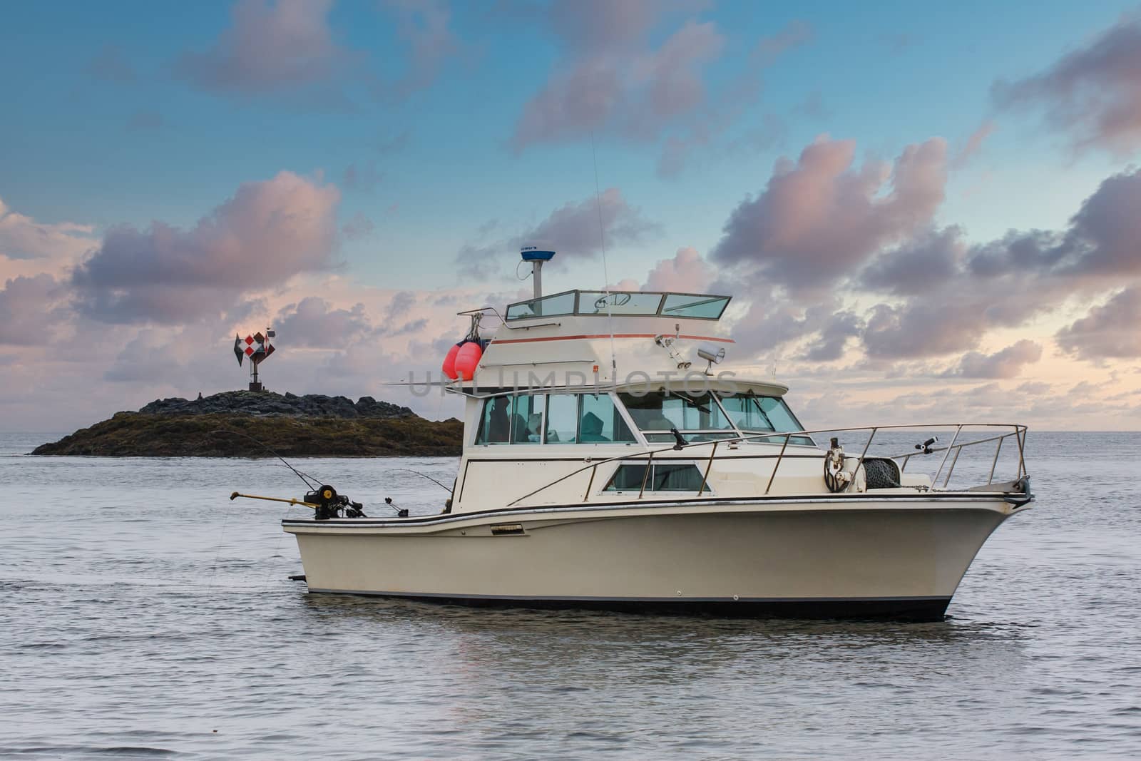 A white fishing boat trawling waters in Alaska