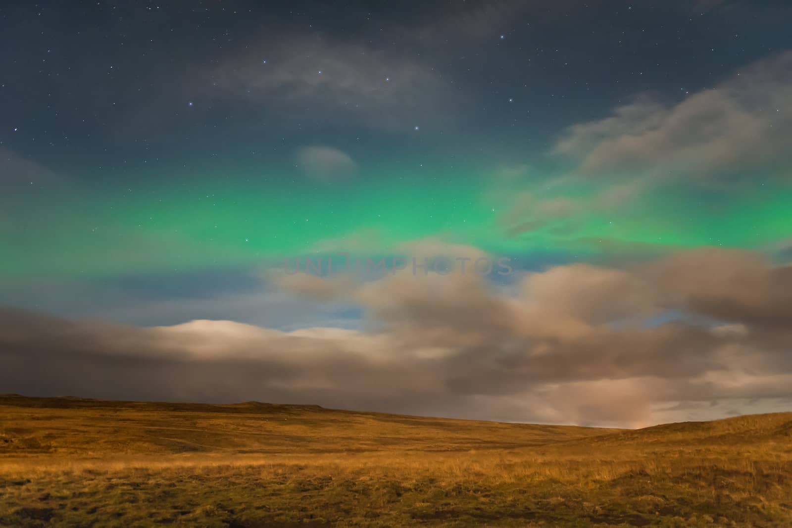 Aurora Borealis in Iceland northern lights shining green in night sky beyond the asterisk Big Dipper by MXW_Stock