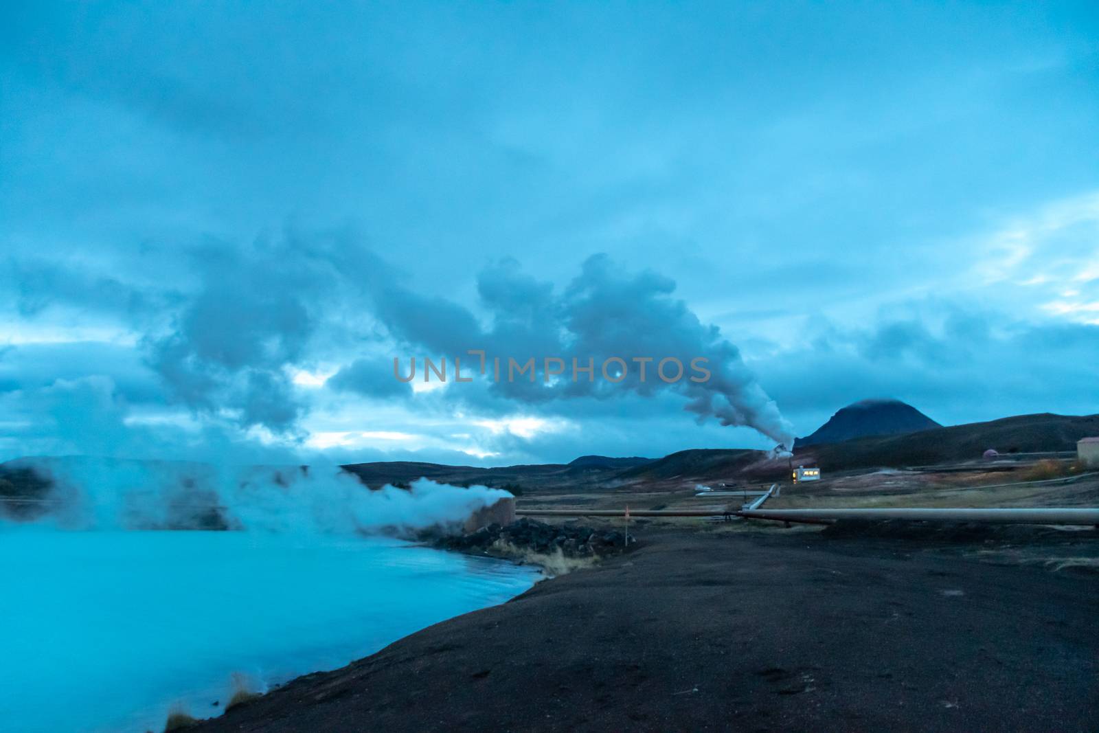 Blue Lake in Iceland geothermal hot lake turquoise water steam pipelines by MXW_Stock